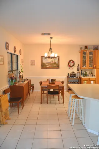 a dining room with furniture and a kitchen view