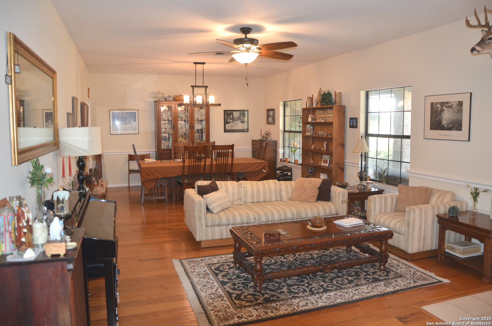 1219 County Road 761 Devine, TX 78016 - Photo 9 of 31 a living room with furniture a rug and a chandelier