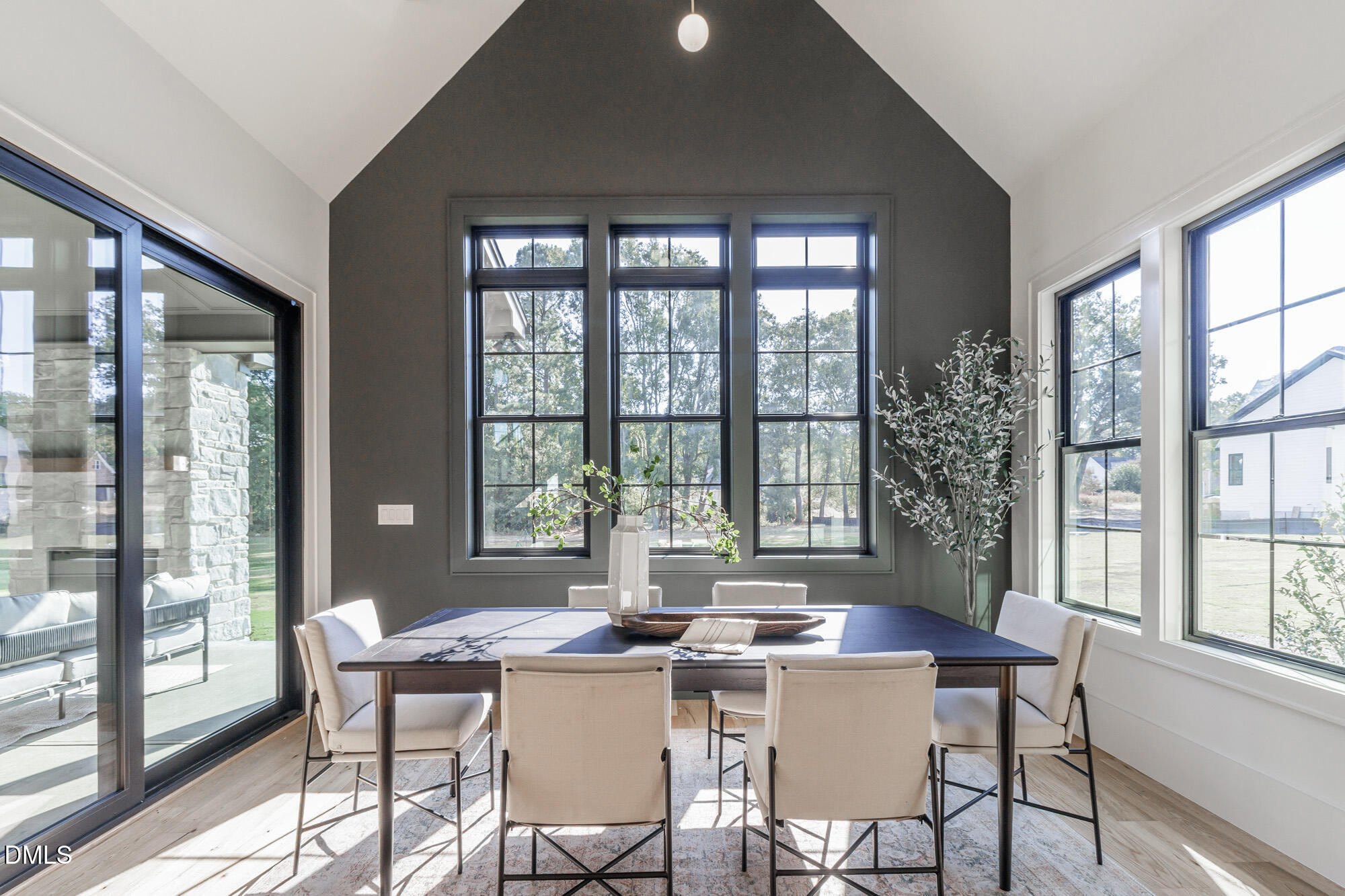 372 Firefly Overlook Pittsboro, NC 27312 - Photo 35 of 85 a view of a dining room with furniture large windows and wooden floor