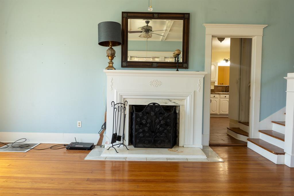 1115 Austin Street Coleman, TX 76834 - Photo 6 of 40 a living room with a fireplace and a fireplace