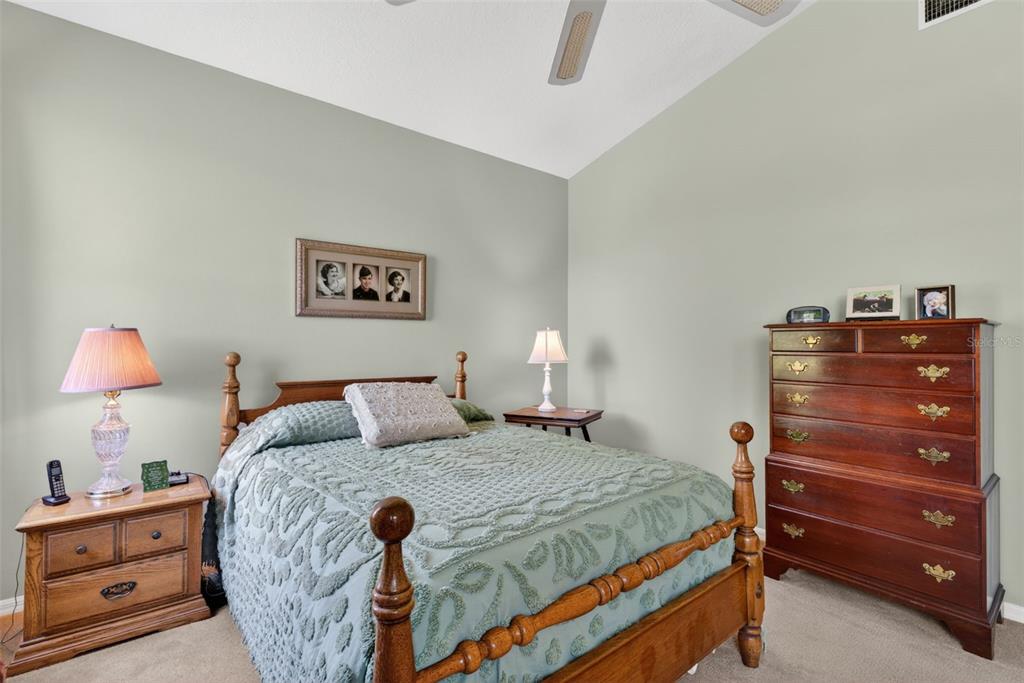 4266 Summertree Road Venice, FL 34293 - Photo 20 of 64 a bedroom with a bed and a lamp on dresser