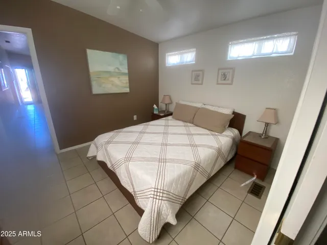 a bedroom with a bed and a mirror