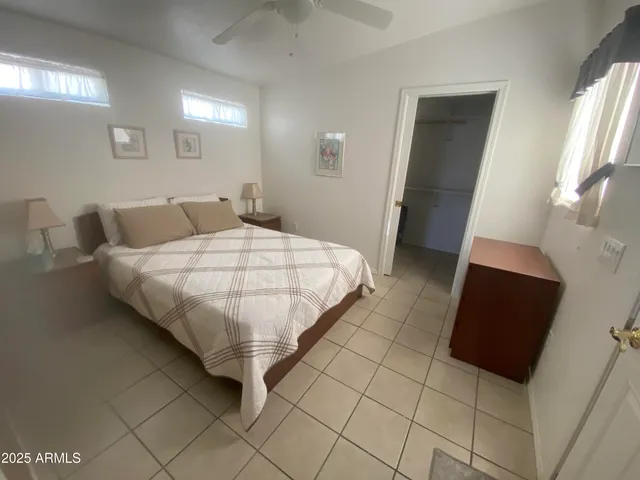 a bed sitting in a bedroom and a mirror