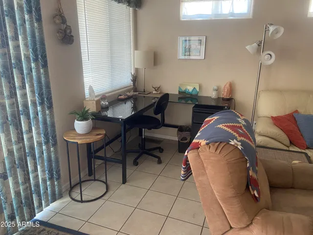 a living room with furniture a rug and white walls