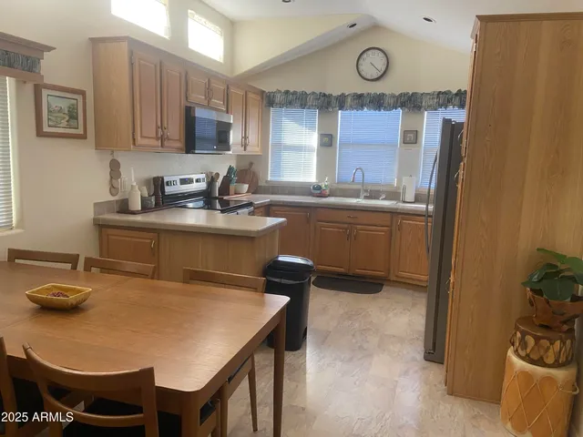 a kitchen with cabinets a sink and appliances
