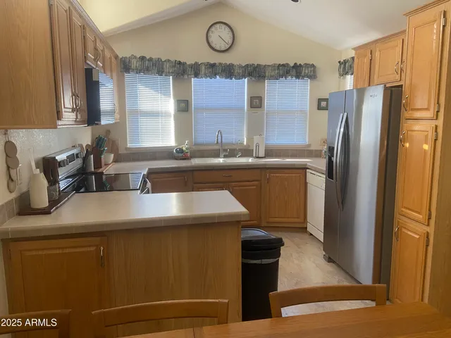 a kitchen with cabinets and wooden floor