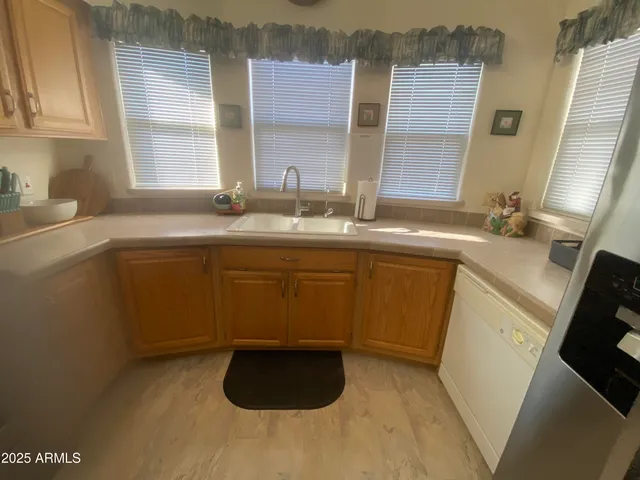 a kitchen with a sink stove and cabinets