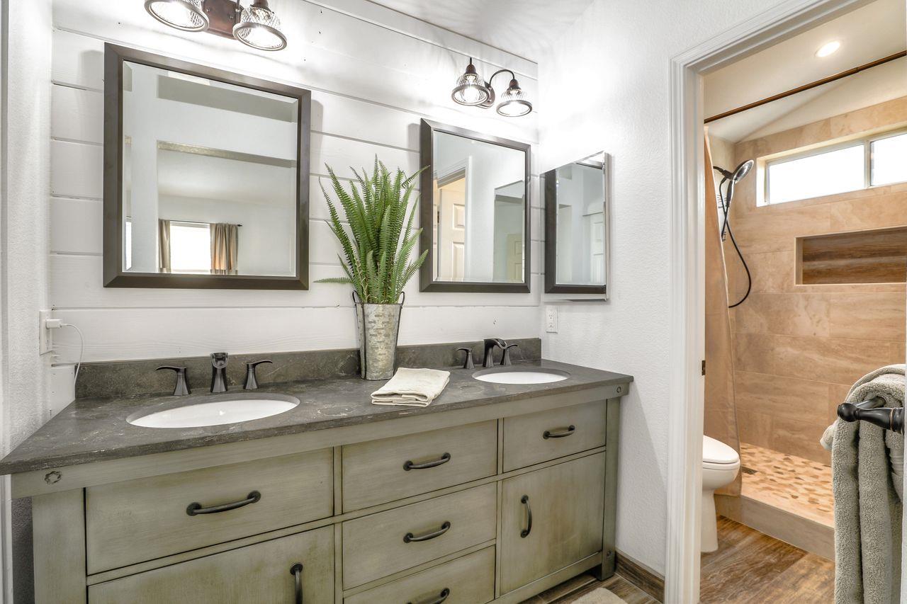 1645 Klipspringer Drive San Jose, CA 95124 - Photo 24 of 47 a bathroom with a double vanity sink and a mirror