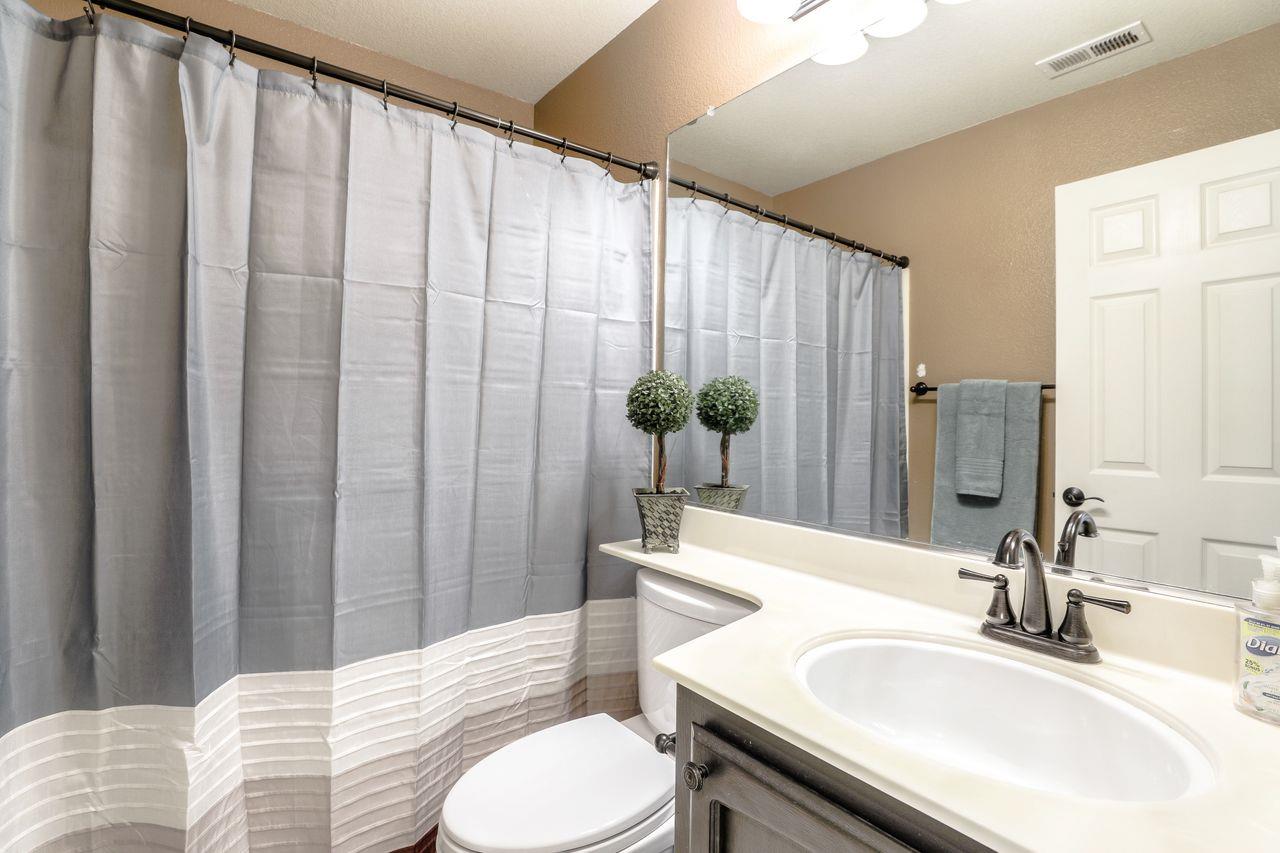 1645 Klipspringer Drive San Jose, CA 95124 - Photo 32 of 47 a bathroom with a granite countertop sink and a mirror