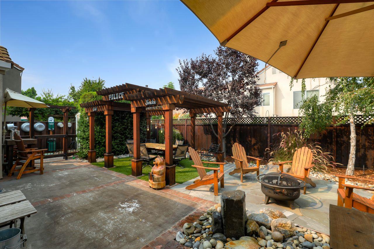 1645 Klipspringer Drive San Jose, CA 95124 - Photo 34 of 47 a view of a patio with table and chairs under an umbrella