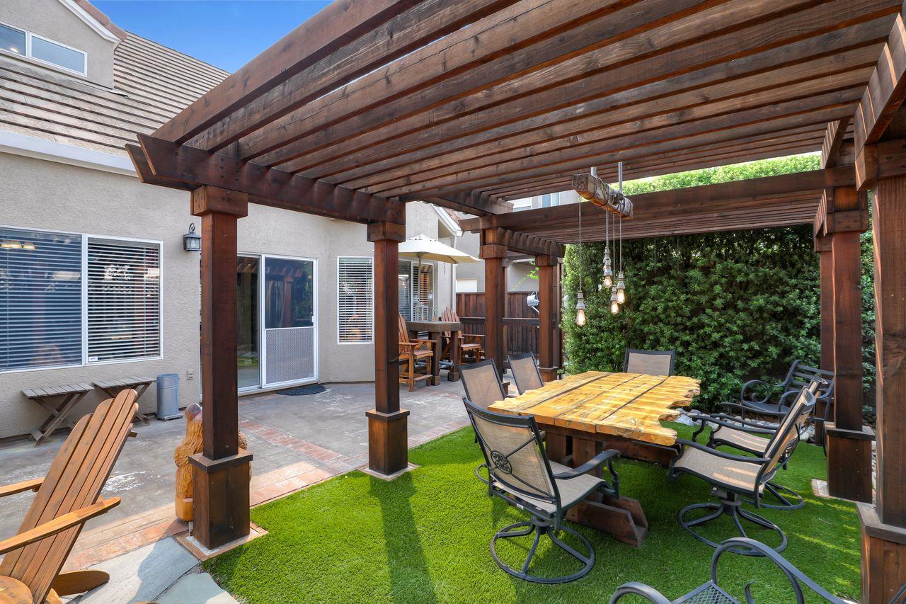1645 Klipspringer Drive San Jose, CA 95124 - Photo 37 of 47 a view of a patio with table and chairs next to a yard