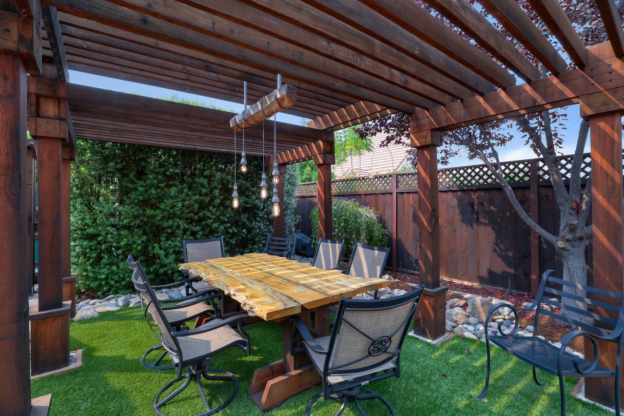 1645 Klipspringer Drive San Jose, CA 95124 - Photo 38 of 47 a view of a backyard with table and chairs with a barbeque grill and plants