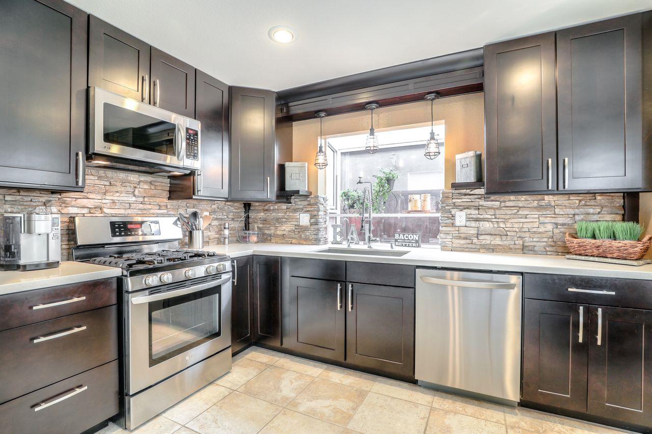 1645 Klipspringer Drive San Jose, CA 95124 - Photo 8 of 47 a kitchen with stainless steel appliances granite countertop a stove a sink and a microwave