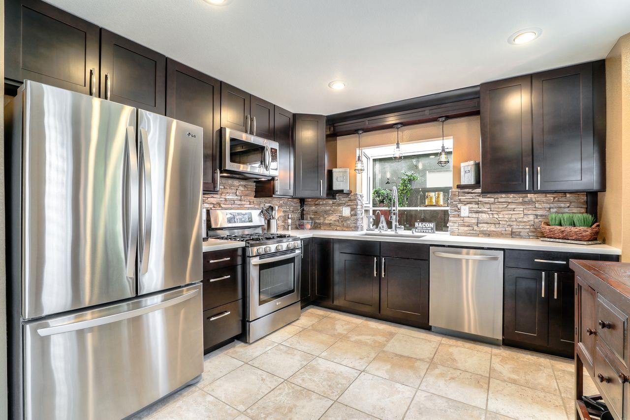 1645 Klipspringer Drive San Jose, CA 95124 - Photo 9 of 47 a kitchen with stainless steel appliances granite countertop a refrigerator stove microwave and sink