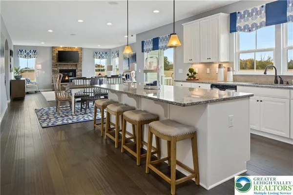 a large kitchen with a table and chairs in it