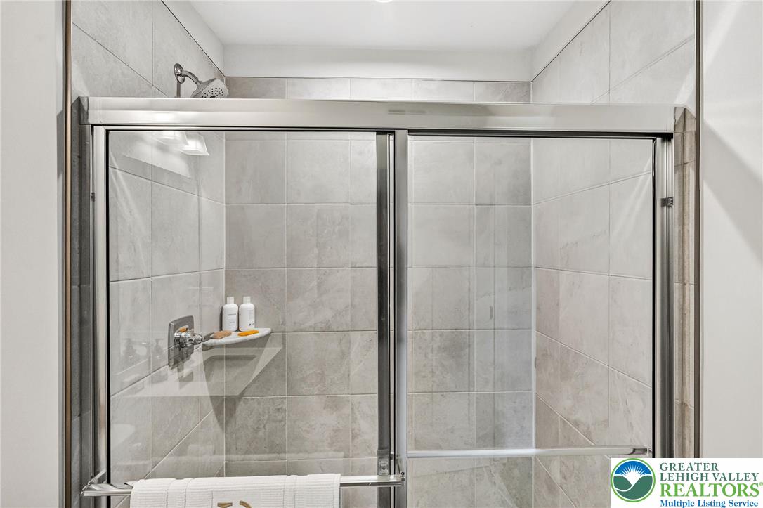 1606 Watson Loop Fogelsville, PA 18051 - Photo 23 of 76 a bathroom with a glass shower door