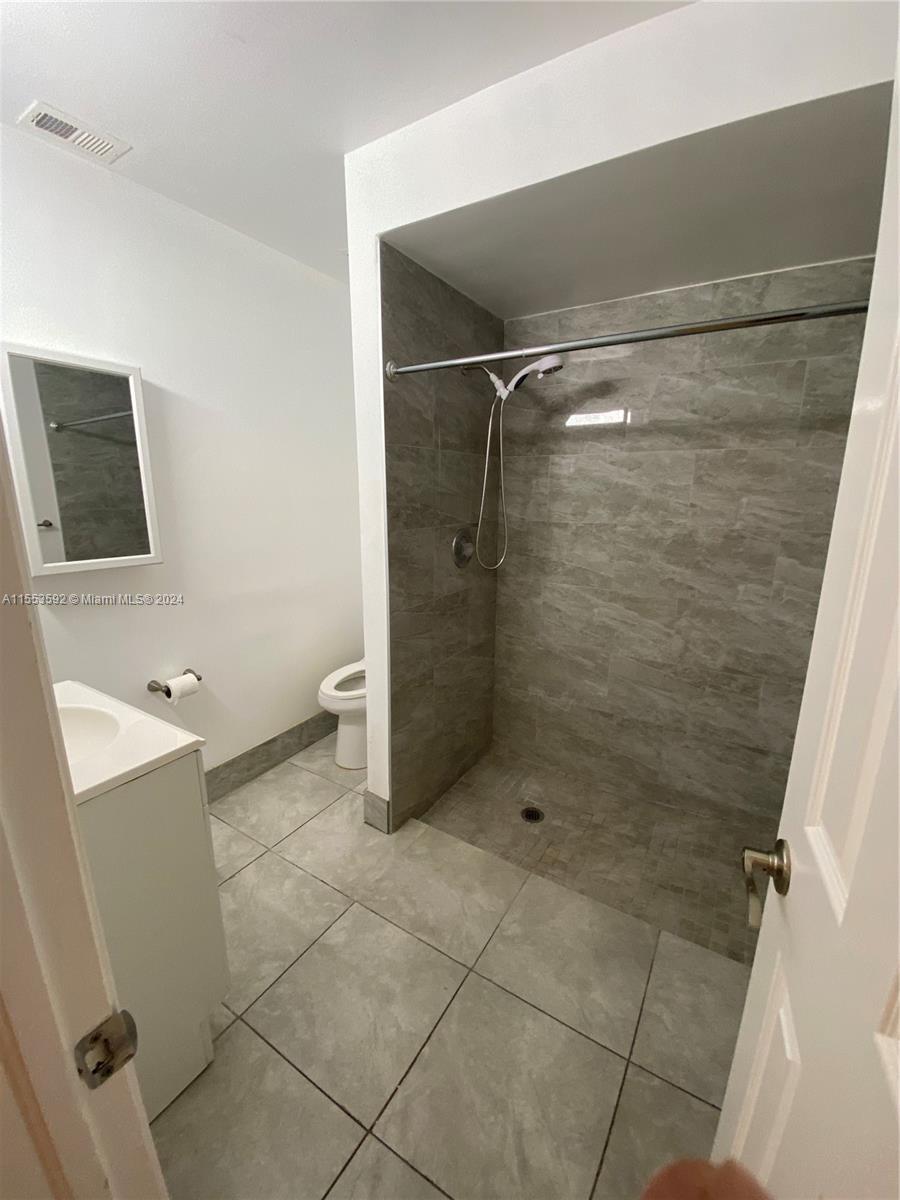 2897 Northeast 2nd Avenue Boca Raton, FL 33431 - Photo 14 of 20 a bathroom with a shower and a sink