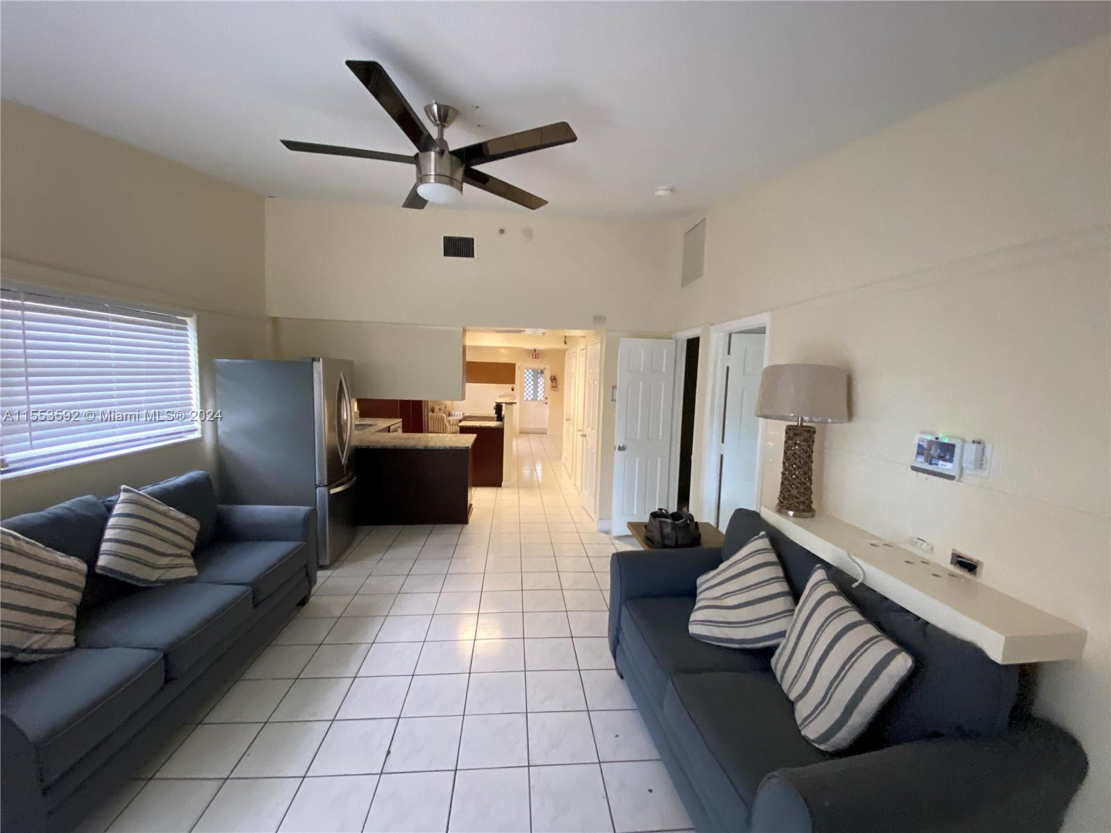 2897 Northeast 2nd Avenue Boca Raton, FL 33431 - Photo 4 of 20 a living room with furniture and a window