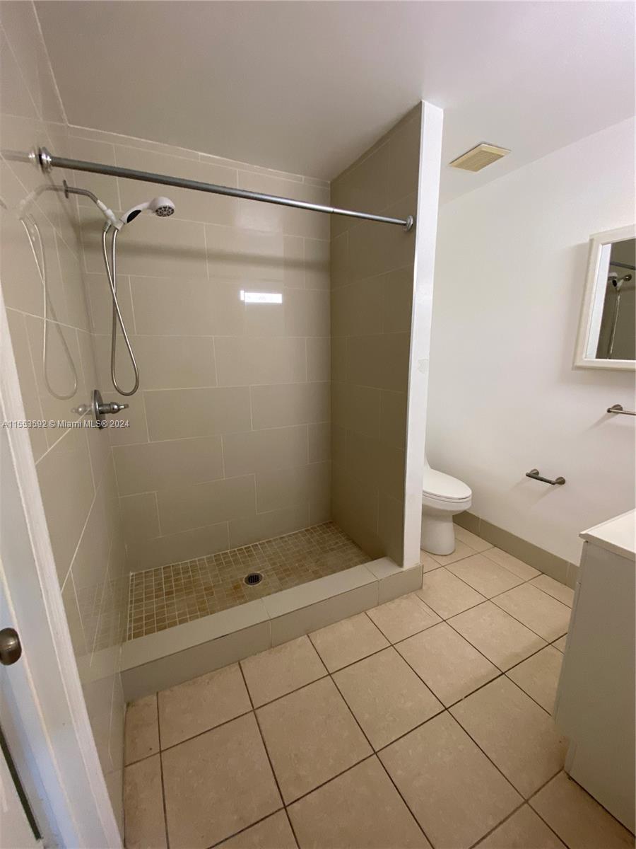 2897 Northeast 2nd Avenue Boca Raton, FL 33431 - Photo 6 of 20 a bathroom with a shower and toilet