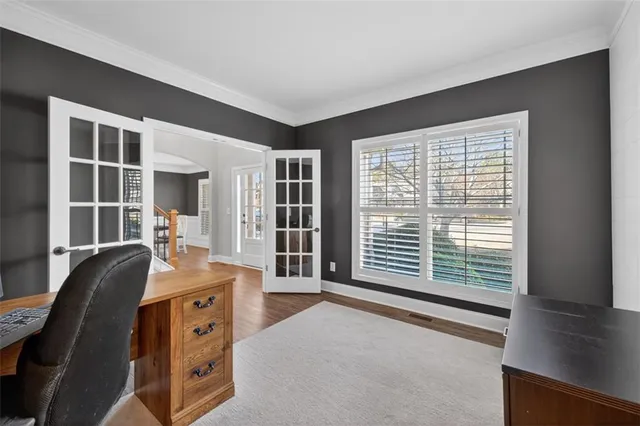 a kitchen with stainless steel appliances kitchen island granite countertop a refrigerator a stove a sink dishwasher and wooden cabinets with wooden floor