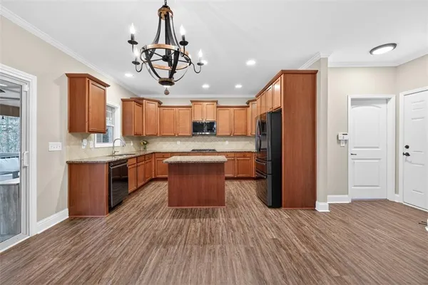a kitchen with stainless steel appliances granite countertop a sink a stove and cabinets