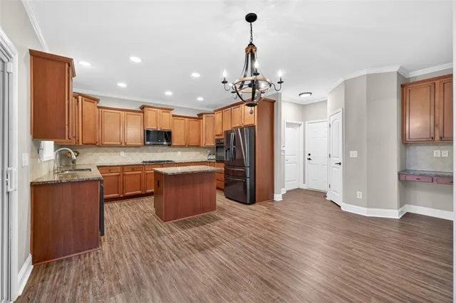 a kitchen with stainless steel appliances granite countertop wooden cabinets a sink and dishwasher