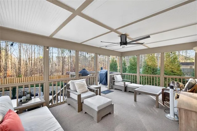 a living room with furniture a fireplace and a large window