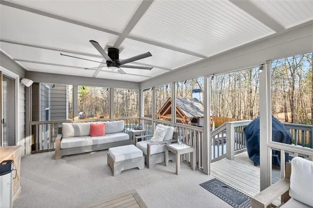 a view of a hallway with wooden floor and stairs