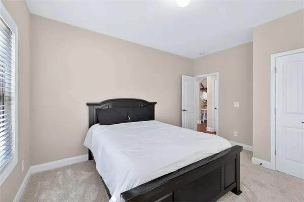 a bed sitting in a bedroom next to a window