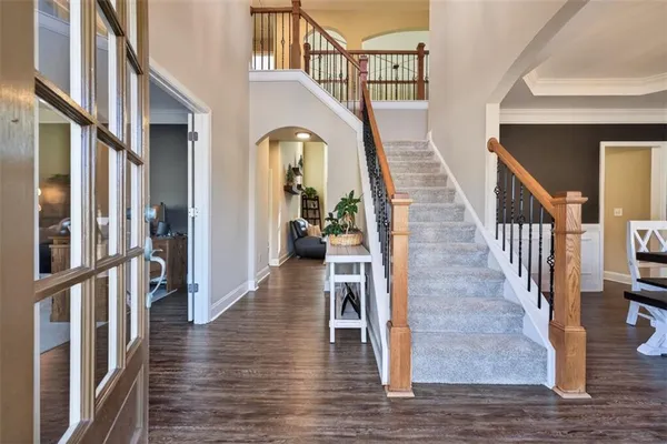 a view of an entryway wooden floor and staircase