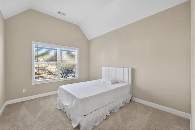 an empty room with furniture and a flat screen tv