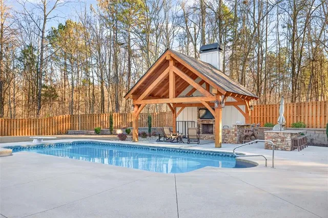 a view of patio with a table and chairs under an umbrella