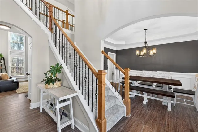 a view of an entryway wooden floor and staircase