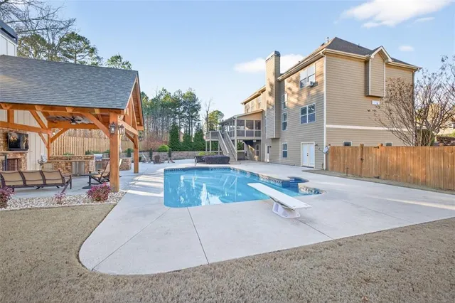 a view of a house with swimming pool and sitting area