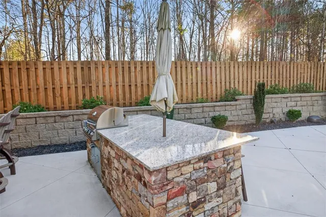 an aerial view of a house with a yard and a large tree