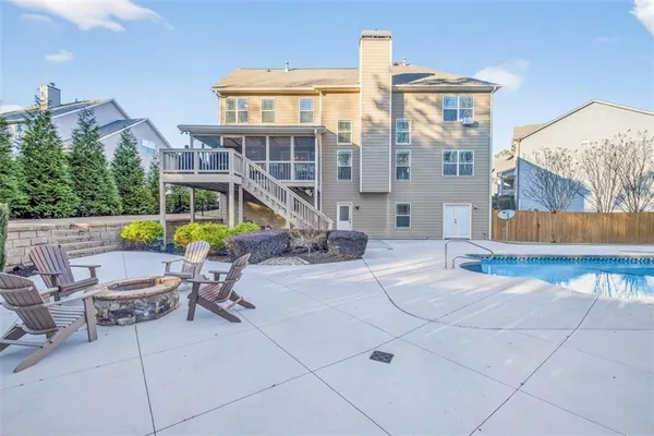 an aerial view of a house with a yard and a large tree