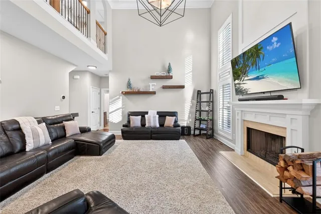 a living room with furniture a flat screen tv and a fireplace