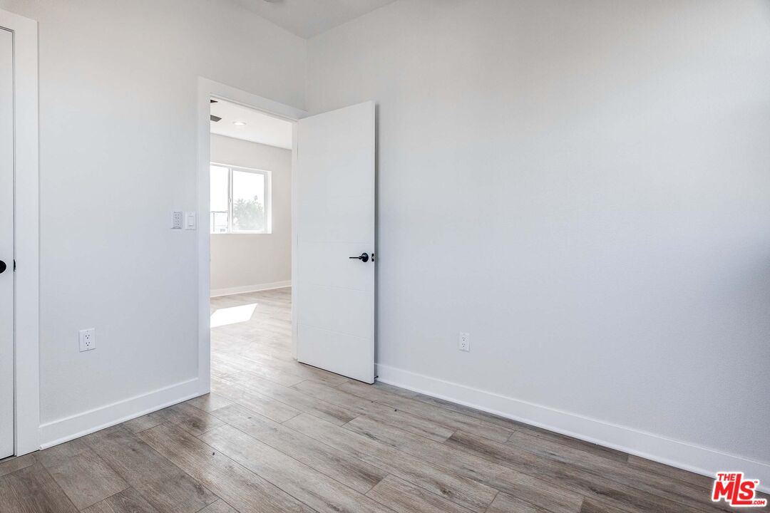 624 West 83rd Street, Unit 624 Los Angeles, CA 90044 - Photo 13 of 26 a view of a hallway with wooden floor