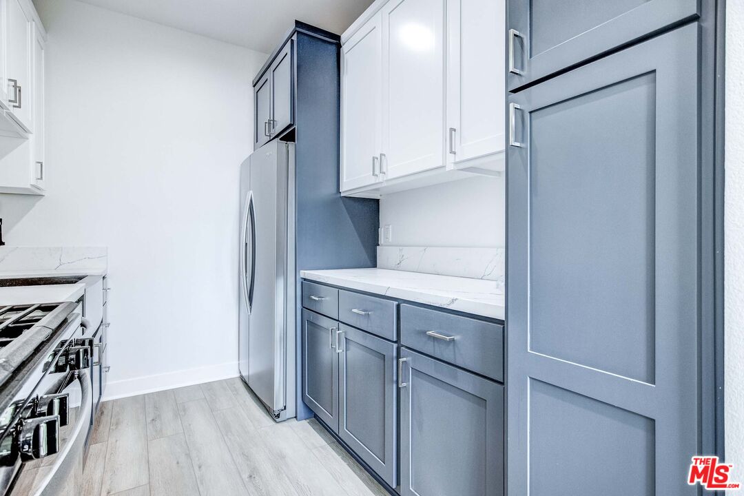624 West 83rd Street, Unit 624 Los Angeles, CA 90044 - Photo 16 of 26 a kitchen with stainless steel appliances granite countertop a refrigerator and a stove top oven
