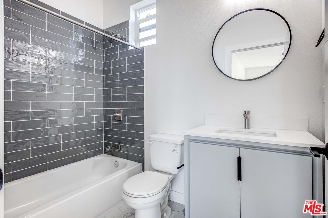624 West 83rd Street, Unit 624 Los Angeles, CA 90044 - Photo 18 of 26 a bathroom with a sink toilet and shower