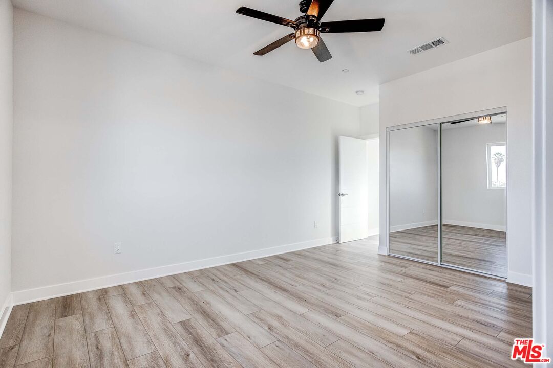 624 West 83rd Street, Unit 624 Los Angeles, CA 90044 - Photo 21 of 26 wooden floor in an empty room
