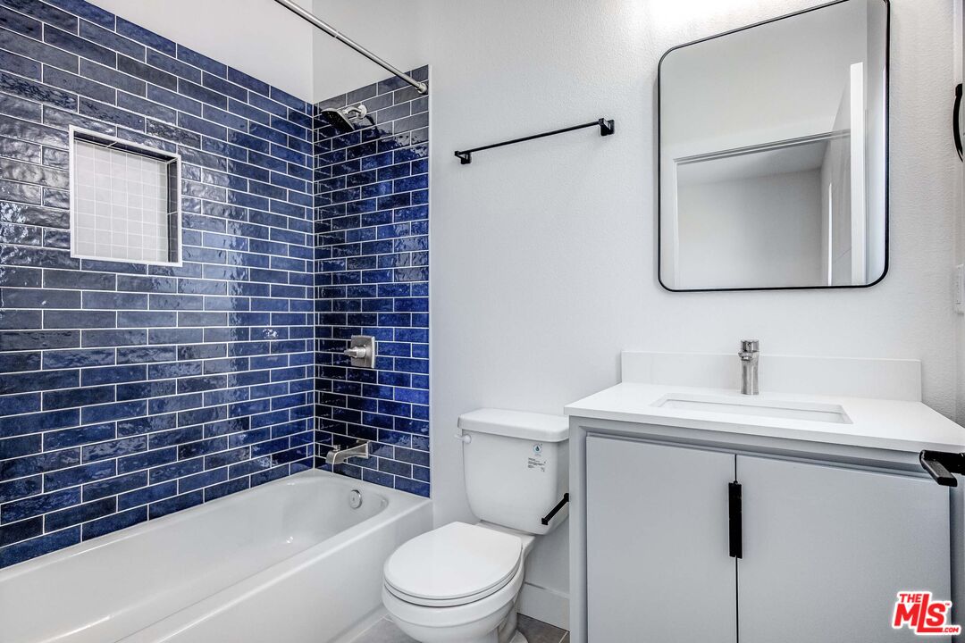 624 West 83rd Street, Unit 624 Los Angeles, CA 90044 - Photo 22 of 26 a bathroom with a sink toilet and shower