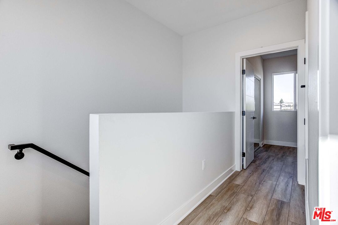 624 West 83rd Street, Unit 624 Los Angeles, CA 90044 - Photo 23 of 26 a view of a hallway with wooden floor