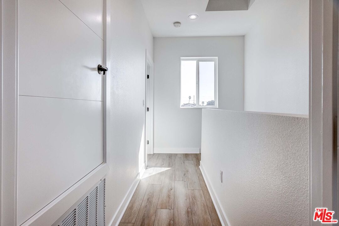 624 West 83rd Street, Unit 624 Los Angeles, CA 90044 - Photo 24 of 26 a view of a hallway with wooden floor