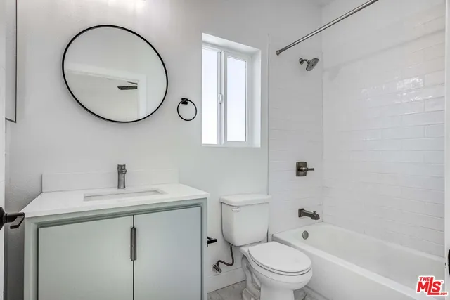a bathroom with a sink toilet and a mirror