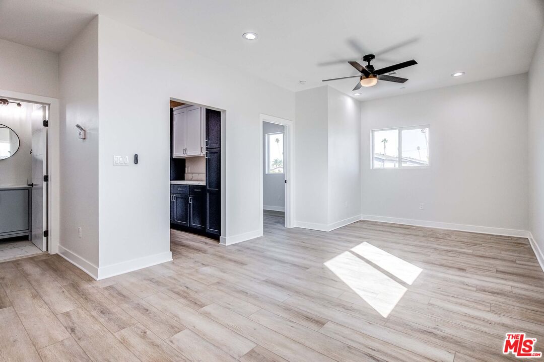 624 West 83rd Street, Unit 624 Los Angeles, CA 90044 - Photo 7 of 26 a view of empty room with wooden floor and window