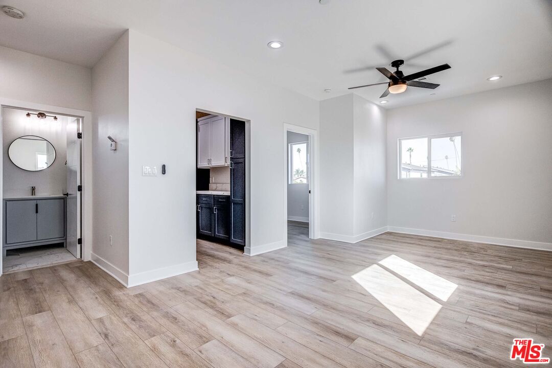 624 West 83rd Street, Unit 624 Los Angeles, CA 90044 - Photo 8 of 26 a view of empty room with wooden floor and fan