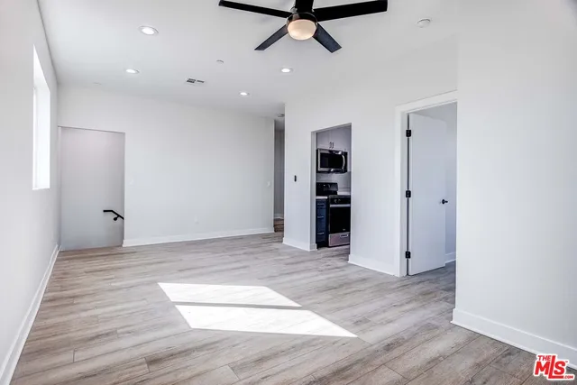 a view of a livingroom with a hardwood floor and a ceiling fan