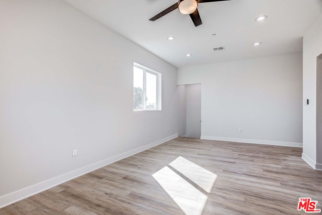 624 West 83rd Street, Unit 624 Los Angeles, CA 90044 - Photo 10 of 26 wooden floor in an empty room with a window