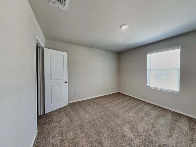 an empty room with a empty space and windows